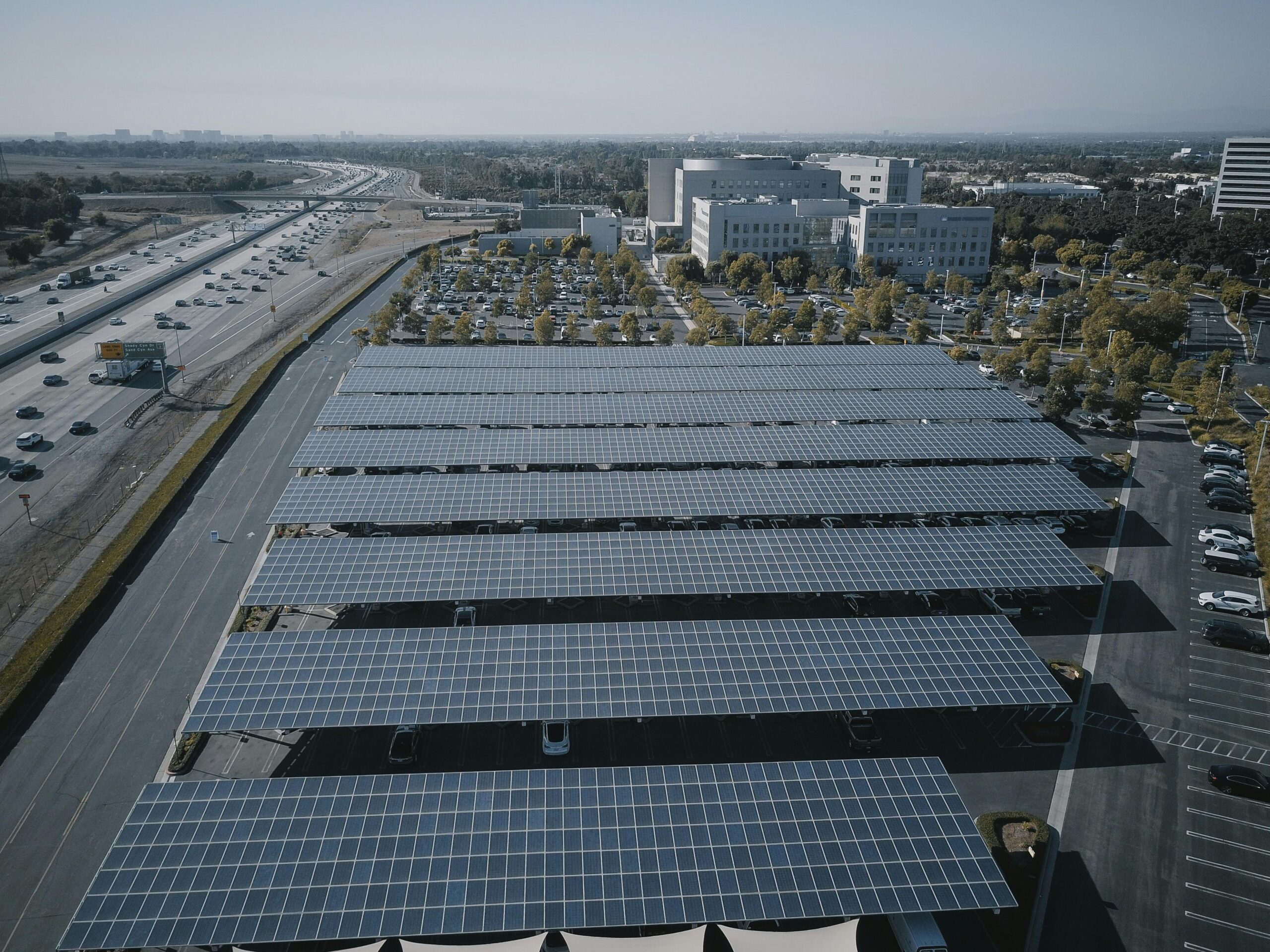 Aerial view of extensive solar panels in an urban setting, showcasing renewable energy.